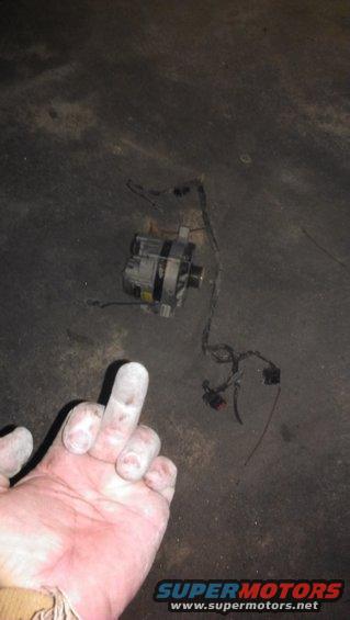 Alternator with wiring on dark surface