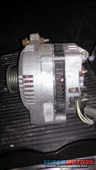 Car alternator with a pulley on the left and wiring on the right. A label on the front reads 'Seville T-90-2'