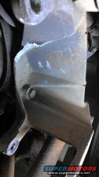 Damaged metal engine bracket with rust and bolt