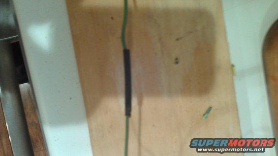 Electrical wire with black heat shrink tubing on a wooden surface