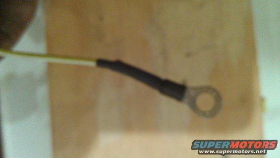 Electrical wire with black heat shrink and a ring terminal, Supermotors logo visible