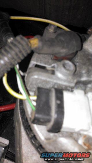 Close-up of alternator wiring with yellow, green, and white wires connected