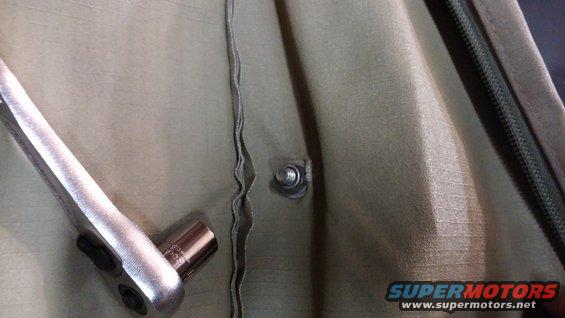Socket wrench and socket on tan awning fabric with a snap fastener
