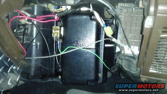 Close-up of vehicle's interior HVAC unit with exposed wiring and components