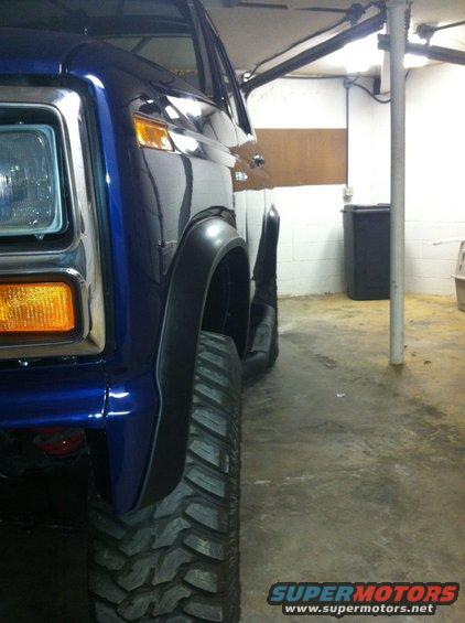Front fender and tire of a blue 1982 Ford Bronco