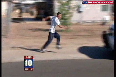 Person in white shirt and dark pants running on a sunny day with blurred background