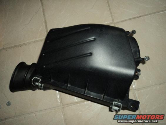 Black plastic air intake box with a hose connection on the left