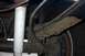 1994 Ford Bronco - Close-up view of the rear leaf spring and shock absorber assembly on a vehicle.