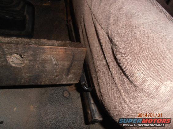 Interior view showing a wooden block and seat fabric
