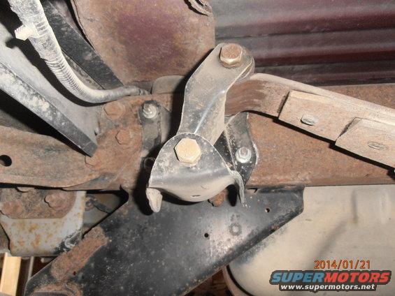 close-up of rusty vehicle suspension part with bolts and metal brackets