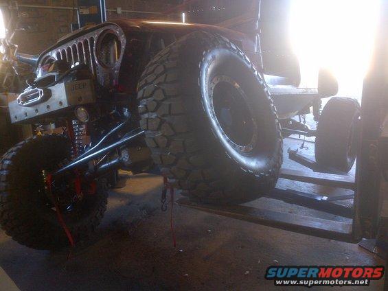1985 Jeep CJ7 front end with custom bumper and large off-road tires, lifted
