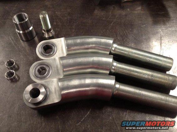 three metal suspension arms with threaded ends and bearings, plus a bolt and threaded sleeve