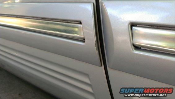 Silver 1996 Lincoln Town Car side door trim with chrome accent