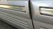 1996 Lincoln Town Car - Detail of the side door trim on a 1996 Lincoln Town Car, showing the chrome accent and ribbed lower section.