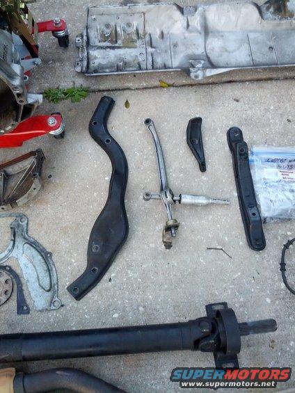 Transmission shifter linkage and driveshaft parts on concrete