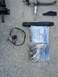 1989 BMW 3 Series - Assorted automotive parts and hardware laid out on a concrete surface.