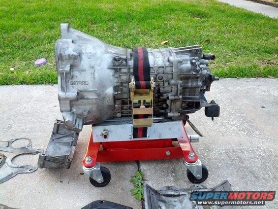Getrag transmission on a red stand, with straps holding it