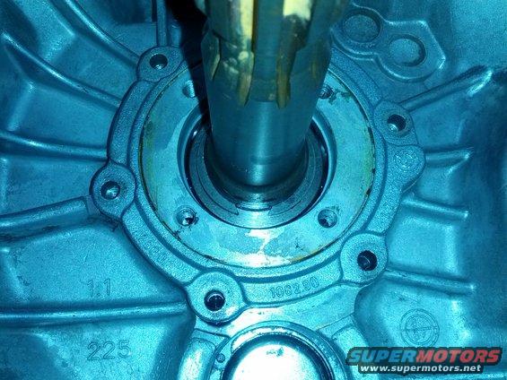 Close-up of a metal transmission housing with a shaft extending from the center