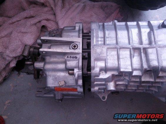 Two aluminum transmission housings are joined together. One has 'LONG' written on it