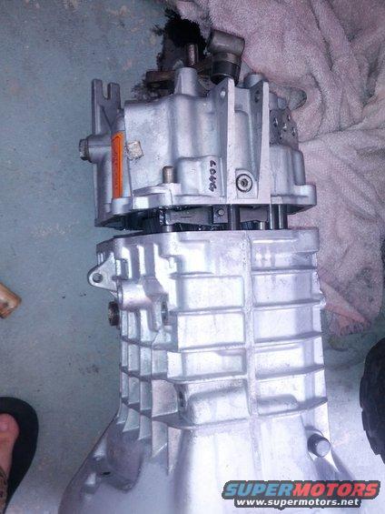 Close-up of a disassembled manual transmission casing with handwritten numbers