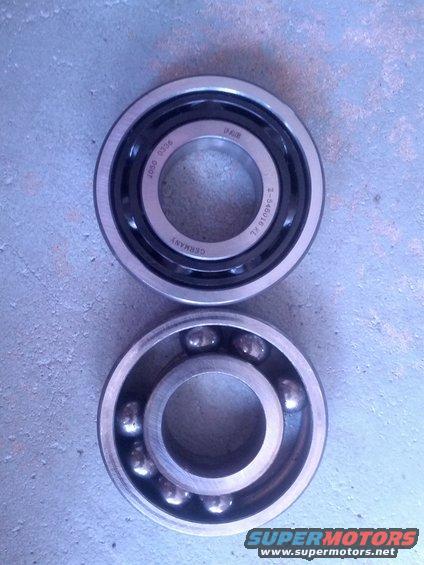 Two ball bearings, one sealed and one open, on a concrete surface
