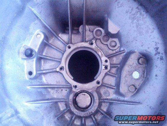 Aluminum transmission bell housing with circular opening and mounting holes