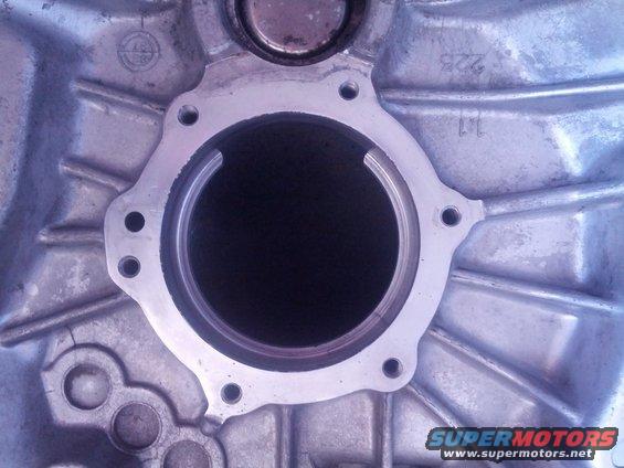 Transmission housing part with circular opening and bolt holes
