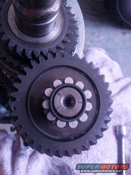 Close-up of gears and bearings, with "275" visible on a metal component