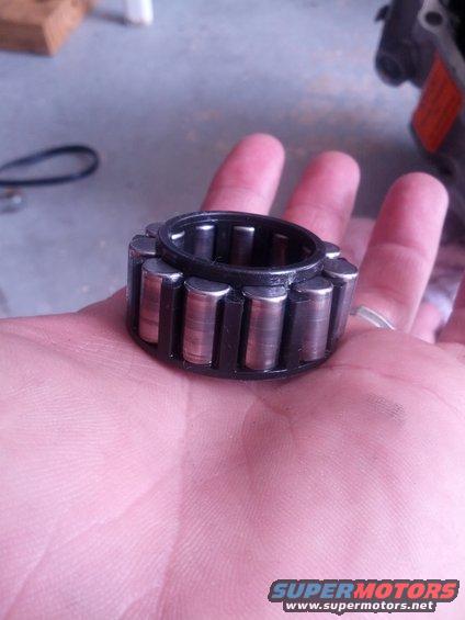 Roller bearing held in palm, with Supermotors.net logo visible