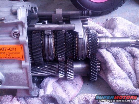 Close-up of transmission gears and housing with an orange label that says ATF-Oil!