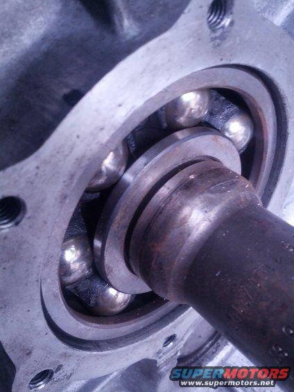 Close-up of a ball bearing assembly with a metal shaft
