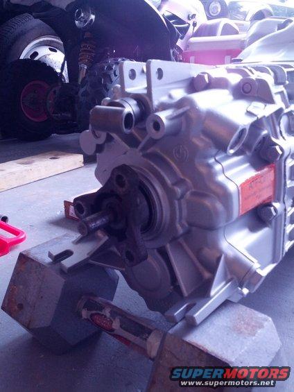 Close-up of a silver BMW transmission housing with a red label