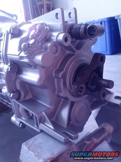 Close-up of a silver transmission housing with some rusty metal parts attached