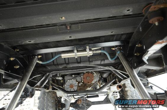 Undercarriage of a modified vehicle showing suspension, transfer case, and exhaust components