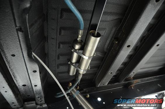 Underbody view of shocks and air suspension components with blue hose