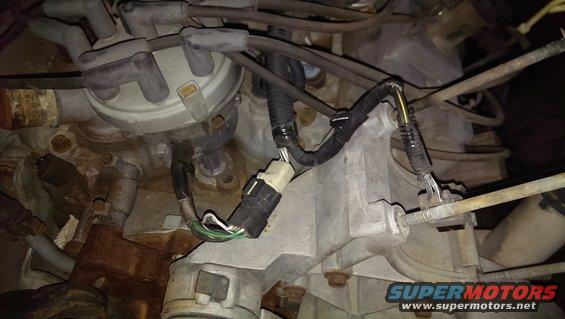 Close-up of an engine distributor with spark plug wires and electrical connectors