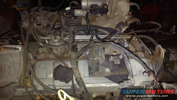 Engine bay with lots of wiring and engine components visible