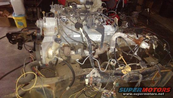 Engine assembly with exposed wiring and hoses, appears disassembled