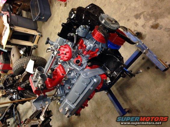 Engine on a stand, painted red and gray with black accents