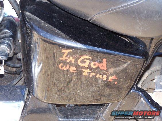 Motorcycle fender with orange text 'In God we trust.'
