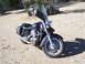 1998 Honda Shadow VT750C - A black cruiser motorcycle is parked outdoors on a sunny day with a shadow cast on the ground.