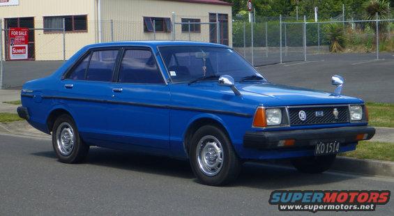 Blue sedan parked curbside, front quarter view. License plate KO 1514