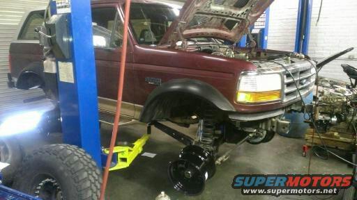 1996 Ford Bronco front view with hood open, on a lift