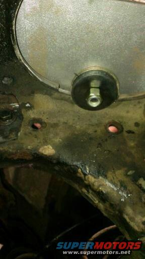 Close-up of vehicle frame part with bolt and rubber mount