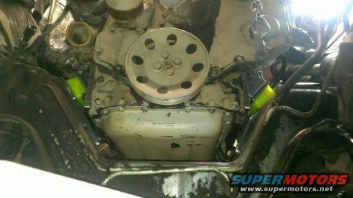 engine block with pulley and yellow hoses