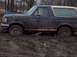 1987 Ford Bronco - This 1987 Ford Bronco is deeply stuck in mud, with its front wheels almost completely submerged.