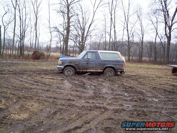 1987 Ford Bronco stuck in mud, side view