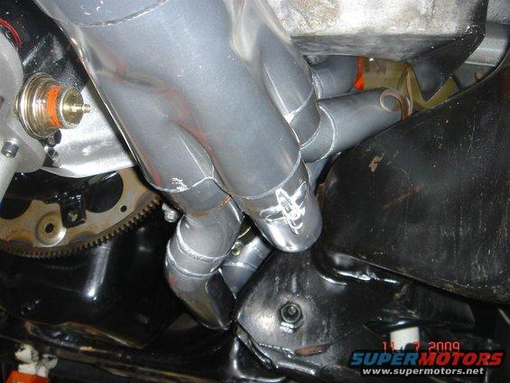 Exhaust manifold pipes and engine block with a date stamp of 11-7-2009
