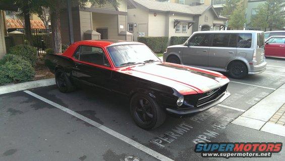 Black and red coupe parked in a lot, 3q-front view