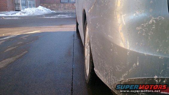 Silver vehicle rear quarter panel and wheel